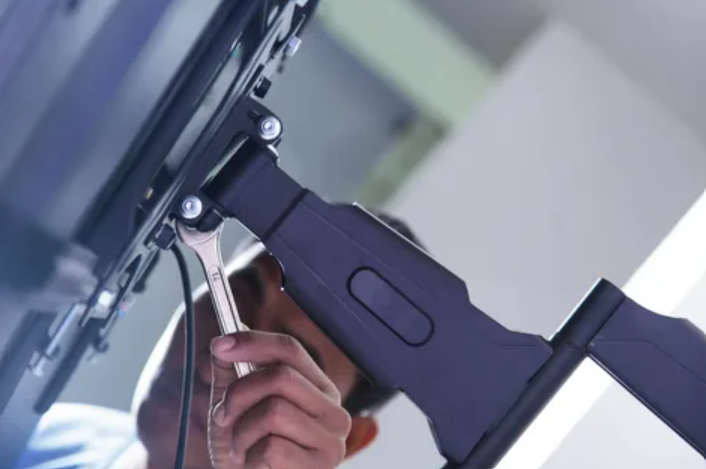 Close-up of television mounting hardware being adjusted